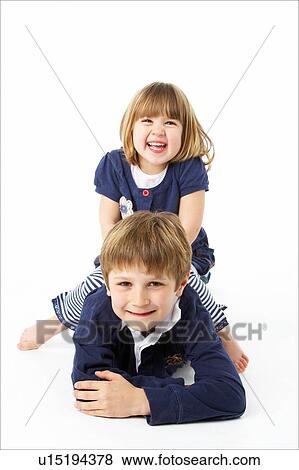 Stock Photo - Studio Portrait Of Happy Brother And Sister. Fotosearch
