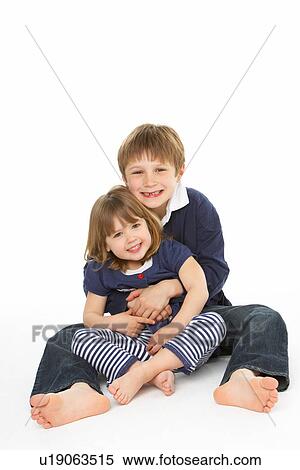 Stock Photography - Studio Portrait Of Happy Brother And Sister. Fotosearch
