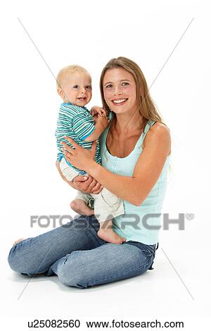 Stock Image - Studio Portrait Of Mother Holding Son. Fotosearch