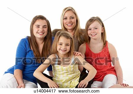 Stock Photo - Studio Portrait Of Mother Hugging Daughters. Fotosearch