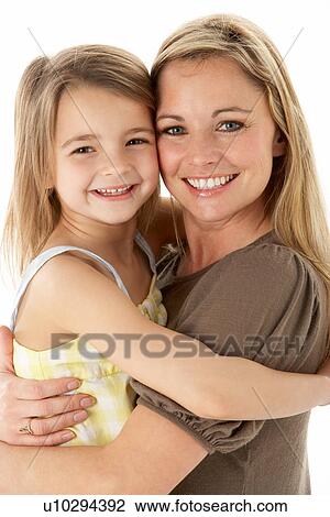 Studio Portrait Of Mother Hugging Young Daughter View Large Photo Image Stock Image - Studio Portrait Of Mother Hugging Young Daughter. Fotosearch