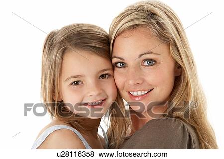 Stock Photo - Studio Portrait Of Mother Hugging Young Daughter. Fotosearch