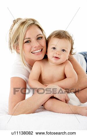 Stock Image - Studio Portrait Of Mother With Young Baby Boy. Fotosearch