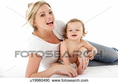 Stock Image - Studio Portrait Of Mother With Young Baby Boy. Fotosearch