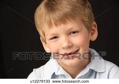 Stock Image - Studio Portrait Of Smiling Boy. Fotosearch