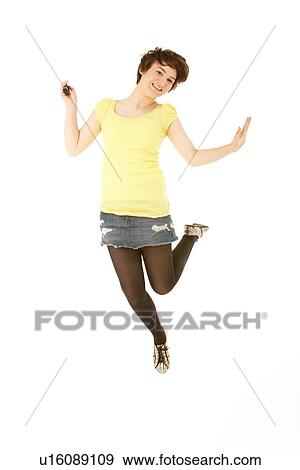 Studio Portrait Of Teenage Girl Jumping In Air View Large Photo Image Stock Photo - Studio Portrait Of Teenage Girl Jumping In Air. Fotosearch