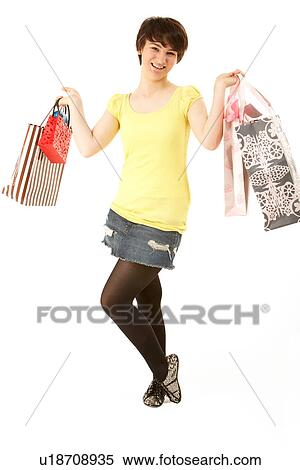 Studio Portrait Of Teenage Girl Carrying Shopping Bags View Large Photo Image Stock Photography - Studio Portrait Of Teenage Girl Carrying Shopping Bags. Fotosearch