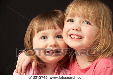 Studio Portrait Of Two Sisters View Large Photo Image Stock Photography - Studio Portrait Of Two Sisters. Fotosearch