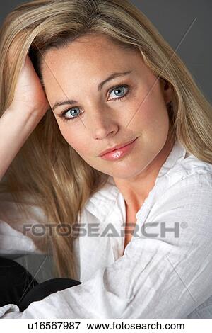 Studio Portrait Of Woman Wearing White Shirt View Large Photo Image Stock Photo - Studio Portrait Of Woman Wearing White Shirt. Fotosearch