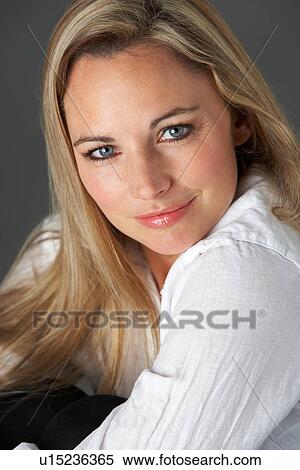Stock Photography - Studio Portrait Of Woman Wearing White Shirt. Fotosearch