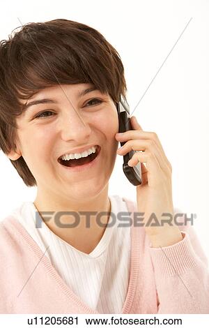 Stock Image - Studio Portrait Of Young Girl Using Mobile Phone. Fotosearch