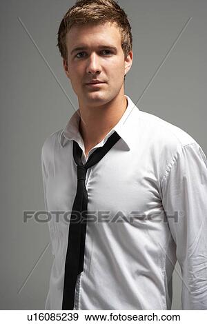 Stock Photo - Studio Portrait Of Young Man Wearing Shirt And Tie. Fotosearch