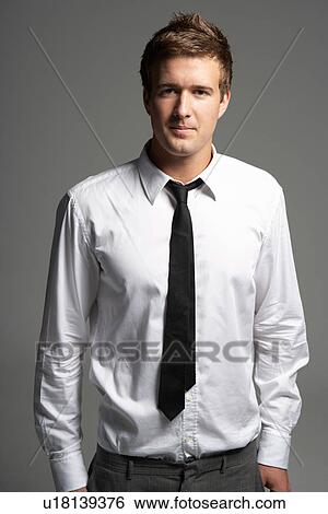 Stock Photograph - Studio Portrait Of Young Man Wearing Shirt And Tie. Fotosearch