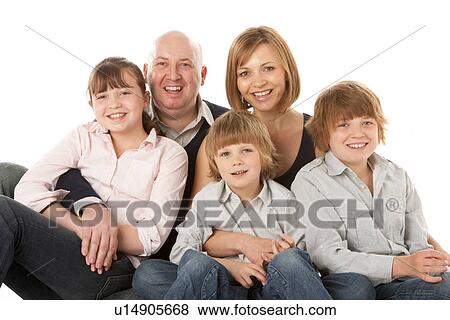 Stock Photo - Studio Shot Of Family Group Sitting In Studio. Fotosearch