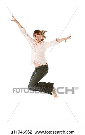 Stock Image - Studio Shot Of Young Girl Jumping In Studio. Fotosearch