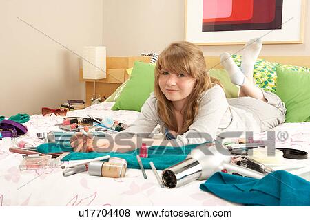Teenage Girl In Untidy Bedroom Painting Nails View Large Photo Image Stock Photo - Teenage Girl In Untidy Bedroom Painting Nails. Fotosearch