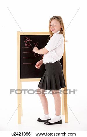 Stock Image - Thoughtful Female Student Wearing Uniform Next To Blackboard. Fotosearch