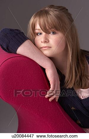 Thoughtful Teenage Girl Relaxing On Chaise Longue View Large Photo Image Stock Photo - Thoughtful Teenage Girl Relaxing On Chaise Longue. Fotosearch