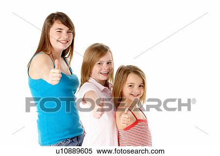 Stock Photography - Three Girls Giving Thumbs Up Gesture In Studio. Fotosearch