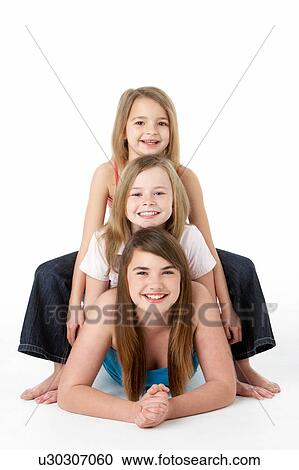 Three Girls laying On Stomach In Studio View Large Photo Image Stock Image - Three Girls laying On Stomach In Studio. Fotosearch