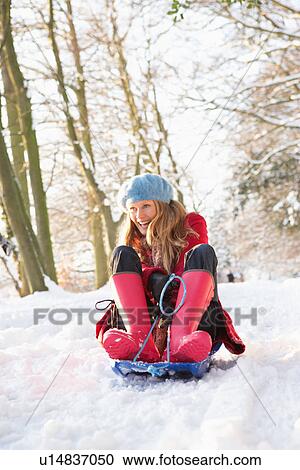 Woman Sledging Through Snowy Woodland View Large Photo Image Stock Image - Woman Sledging Through Snowy Woodland. Fotosearch