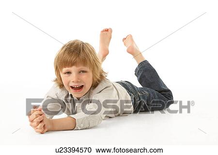 Young Boy Lying On Stomach In Studio View Large Photo Image Stock Image - Young Boy Lying On Stomach In Studio. Fotosearch