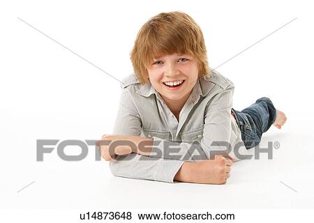 Stock Photo - Young Boy Lying On Stomach In Studio. Fotosearch