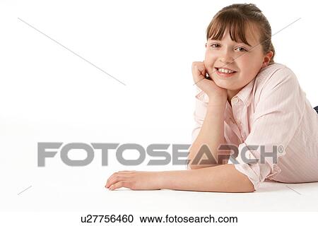 Stock Image - Young Girl Lying On Stomach In Studio. Fotosearch