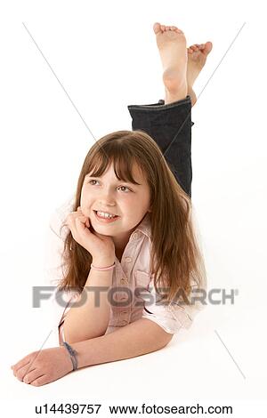 Stock Photo - Young Girl Lying On Stomach In Studio. Fotosearch