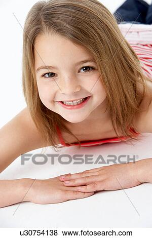 Young Girl Lying On Stomach In Studio View Large Photo Image Stock Photo - Young Girl Lying On Stomach In Studio. Fotosearch