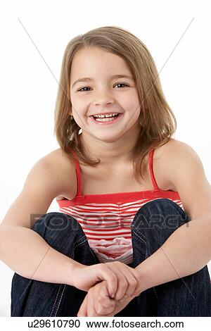 Stock Image - Young Girl Sitting In Studio. Fotosearch