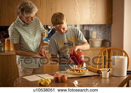 12 year old boy placing peaches into pie shell with great grandmother; Redvers, Saskatchewan, Canada View Large Photo Image Stock Image - 12 year old boy placing peaches into pie shell with great grandmother; Redvers, Saskatchewan, Canada. Fotosearch
