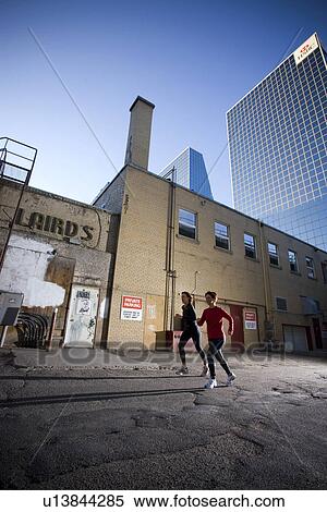 2 women running at rear of downtown buildings, Regina, Saskatchewan View Large Photo Image Stock Photography - 2 women running at rear of downtown buildings, Regina, Saskatchewan. Fotosearch