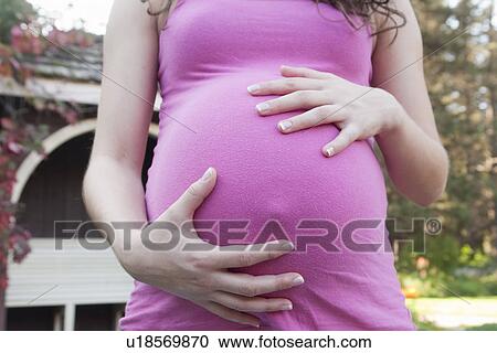 Stock Image - Abdomen of pregnant woman, Manitoba, Canada. Fotosearch