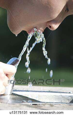 Asian woman drinks from water fountain in Assiniboine Park, Winnipeg, Canada View Large Photo Image Stock Image - Asian woman drinks from water fountain in Assiniboine Park, Winnipeg, Canada. Fotosearch