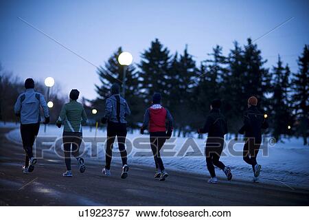 Stock Photo - Back view of group of 6 runners out in winter morning, Regina, Saskatchewan. Fotosearch