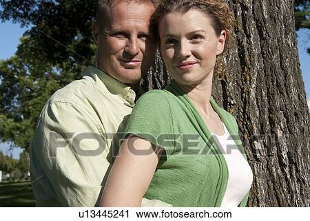 Couple embrace beside tree in Assiniboine Park, Winnnipeg, Canada View Large Photo Image Stock Image - Couple embrace beside tree in Assiniboine Park, Winnnipeg, Canada. Fotosearch