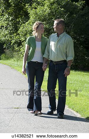 Couple in their 40's walking in Assiniboine Park, Winnipeg, Canada View Large Photo Image Stock Image - Couple in their 40's walking in Assiniboine Park, Winnipeg, Canada. Fotosearch