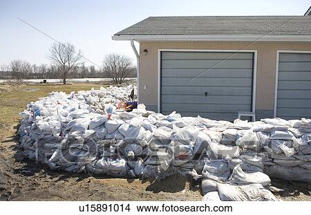 Dyke of sandbags around rural home to protect from Red River floodwaters, rural Manitoba View Large Photo Image Picture - Dyke of sandbags around rural home to protect from Red River floodwaters, rural Manitoba. Fotosearch