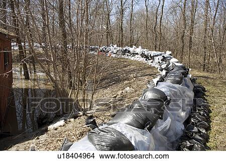 Dyke of sandbags around rural home to protect from Red River floodwaters, rural Manitoba View Large Photo Image Picture - Dyke of sandbags around rural home to protect from Red River floodwaters, rural Manitoba. Fotosearch
