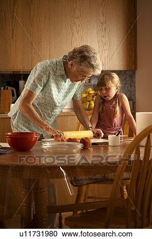 Five year old girl and her great-grandmother roll out pastry; Redvers, Saskatchewan, Canada View Large Photo Image Stock Image - Five year old girl and her great-grandmother roll out pastry; Redvers, Saskatchewan, Canada. Fotosearch