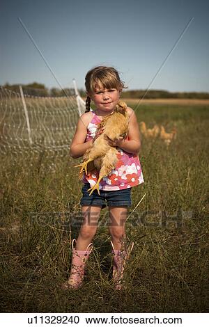 Five year old girl holding heritage breed, free-range chicken; Redvers, Saskatchewan, Canada View Large Photo Image Stock Image - Five year old girl holding heritage breed, free-range chicken; Redvers, Saskatchewan, Canada. Fotosearch