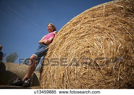 Girl (10) beside large straw bale; Redvers, Saskatchewan, Canada View Large Photo Image Stock Photography - Girl (10) beside large straw bale; Redvers, Saskatchewan, Canada. Fotosearch