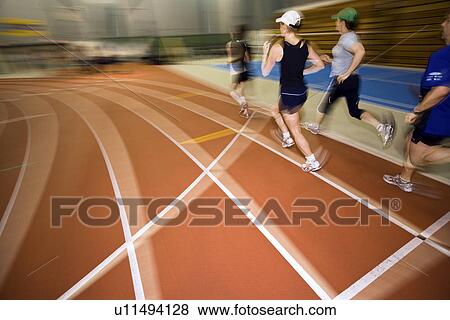 Stock Photo - Group of runner on indoor track, Regina, Saskatchewan. Fotosearch