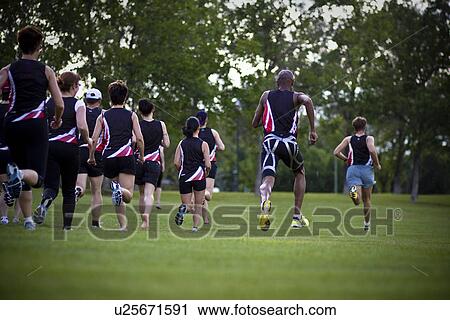 Stock Image - Group of runners training in park, Regina, Saskatchewan. Fotosearch