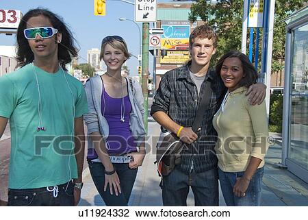Stock Image - Groups of teens on street, Winnipeg, Manitoba, Canada. Fotosearch