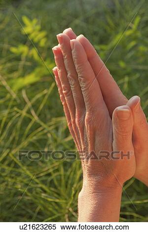 Stock Photography - Hands held together, Manitoba, Canada. Fotosearch