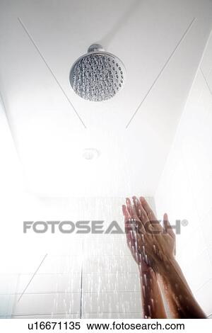 Stock Photography - Hands under low-flow shower head. Fotosearch