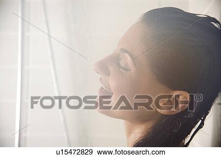 Head shot of woman in steamy shower stall with low flow faucet. View Large Photo Image Stock Photo - Head shot of woman in steamy shower stall with low flow faucet.. Fotosearch