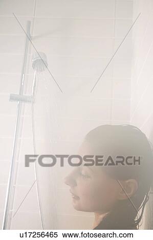 Head shot of woman in steamy shower stall with low flow faucet. View Large Photo Image Stock Photography - Head shot of woman in steamy shower stall with low flow faucet.. Fotosearch
